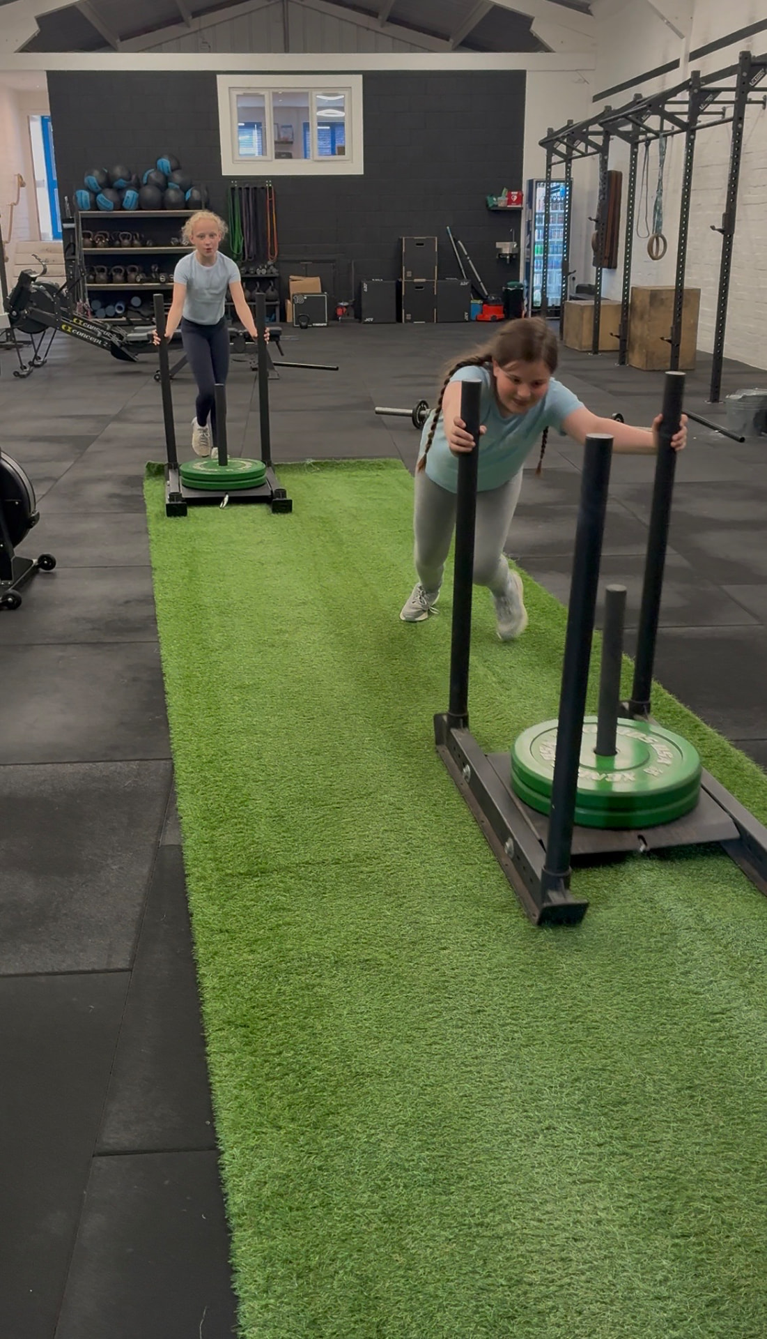 Children pushing sleds during a CrossFit Kids class at Grand Union CrossFit in Berkhamsted